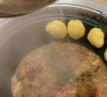 Stewed Rooster in Iron Pot