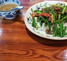 Stir-fried garlic shoots with pork over rice