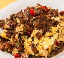 Grandmother's Vegetable Stir-Fry with Egg in Wooden Bowl Rice